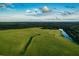 Scenic aerial view of a green landscape featuring walking paths and a winding river at 8924 Misty Creek Dr, Sarasota, FL 34241