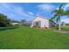 Home exterior with spacious backyard, screened-in patio, and lush green lawn at 8924 Misty Creek Dr, Sarasota, FL 34241