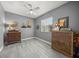 A cozy bedroom with hardwood floors, ceiling fan, natural light, and charming decor at 8924 Misty Creek Dr, Sarasota, FL 34241