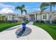 Home exterior with lush green lawn, a decorative water feature, and a welcoming entrance at 8924 Misty Creek Dr, Sarasota, FL 34241