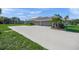 Exterior view featuring a large driveway and three-car garage at 8924 Misty Creek Dr, Sarasota, FL 34241