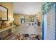 Inviting foyer with wood-look tile, an open floor plan, and a dining area with a chandelier at 8924 Misty Creek Dr, Sarasota, FL 34241