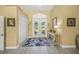 Bright foyer with double doors, neutral walls, tile floors, and a decorative console table at 8924 Misty Creek Dr, Sarasota, FL 34241