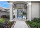 Elegant front entrance featuring double doors, columns, and beautiful landscaping at 8924 Misty Creek Dr, Sarasota, FL 34241