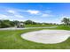 Well-manicured golf course featuring a sand trap with golfers and carts nearby at 8924 Misty Creek Dr, Sarasota, FL 34241