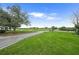 Scenic golf course view featuring lush green fairways, mature trees and a clear blue sky at 8924 Misty Creek Dr, Sarasota, FL 34241