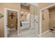 Hallway showing bathroom, living area and walk-in closet with neutral paint and wood-look tile flooring at 8924 Misty Creek Dr, Sarasota, FL 34241