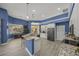 Stylish kitchen with granite countertops, stainless appliances, a breakfast bar, and blue walls at 8924 Misty Creek Dr, Sarasota, FL 34241