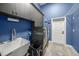 Well-equipped laundry room with washer, dryer, storage cabinets, and utility sink at 8924 Misty Creek Dr, Sarasota, FL 34241