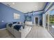 Open-concept living area featuring modern decor, blue walls, recessed lighting, and access to the outdoor pool at 8924 Misty Creek Dr, Sarasota, FL 34241