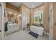 A spa-like bathroom featuring a soaking tub, dual sinks, large mirror and walk-in shower at 8924 Misty Creek Dr, Sarasota, FL 34241