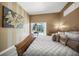 A spacious main bedroom with neutral colors, featuring a view to the pool area through sliding glass doors at 8924 Misty Creek Dr, Sarasota, FL 34241