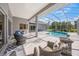 Inviting screened-in pool area with comfortable seating, a built-in grill, and a relaxing atmosphere at 8924 Misty Creek Dr, Sarasota, FL 34241