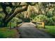 Scenic wooden bridge surrounded by lush greenery and trees draped with Spanish moss, creating a serene park setting at 8924 Misty Creek Dr, Sarasota, FL 34241
