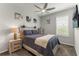 Cozy bedroom with wood-accented headboard, ceiling fan, and neutral walls at 9012 Tequila Sunrise Dr, Sarasota, FL 34241