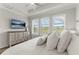 Bright bedroom with plantation shutters, complemented by a dresser and TV for relaxation and style at 9012 Tequila Sunrise Dr, Sarasota, FL 34241