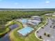 Aerial shot of community center with a pool, pond, modern buildings and parking area at 9012 Tequila Sunrise Dr, Sarasota, FL 34241