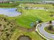 Aerial view of dog park near a scenic pond with lush greenery and walking paths at 9012 Tequila Sunrise Dr, Sarasota, FL 34241