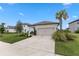 Exterior shot of the well-maintained home, with a paved driveway and neatly trimmed landscaping at 9012 Tequila Sunrise Dr, Sarasota, FL 34241