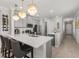 Bright, stylish kitchen featuring a large center island, pendant lights, and stainless steel appliances at 9012 Tequila Sunrise Dr, Sarasota, FL 34241