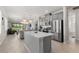 Contemporary kitchen with stainless steel appliances, gray cabinets, and an island, perfect for cooking and entertaining at 9012 Tequila Sunrise Dr, Sarasota, FL 34241