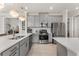 Well-lit kitchen featuring gray cabinetry, stainless steel appliances, and an open layout at 9012 Tequila Sunrise Dr, Sarasota, FL 34241