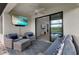 Cozy screened lanai with comfortable seating, ceiling fan, and a view of the pond at 9012 Tequila Sunrise Dr, Sarasota, FL 34241