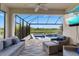 Screened lanai with comfortable seating and view of the pool and waterfront at 9012 Tequila Sunrise Dr, Sarasota, FL 34241