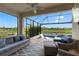 Screened lanai with comfortable seating and a view of the pool and pond at 9012 Tequila Sunrise Dr, Sarasota, FL 34241