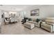Open-concept living room with dining area, neutral tones, and tile floors, creating a modern and inviting space at 9012 Tequila Sunrise Dr, Sarasota, FL 34241