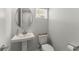 Clean powder room featuring a pedestal sink, modern faucet, and neutral walls at 9012 Tequila Sunrise Dr, Sarasota, FL 34241
