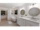 Bright bathroom featuring a clawfoot tub, double sinks, and a window to a dressing room at 9122 16Th Avenue Nw Cir, Bradenton, FL 34209