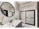Bathroom featuring a round mirror, patterned wallpaper, and a shower at 9122 16Th Avenue Nw Cir, Bradenton, FL 34209