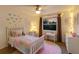Bright bedroom with a large window, ceiling fan, and pink accents at 9122 16Th Avenue Nw Cir, Bradenton, FL 34209