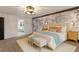 Beautiful bedroom featuring a decorative wall, modern lighting, and stylish furnishings at 9122 16Th Avenue Nw Cir, Bradenton, FL 34209