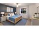 This bedroom features a bed, a large window, a ceiling fan, and two bedside tables at 9122 16Th Avenue Nw Cir, Bradenton, FL 34209