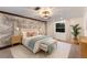 Calming bedroom features an accent wall, a light fixture, and soft, neutral decor at 9122 16Th Avenue Nw Cir, Bradenton, FL 34209