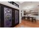 Elegant entryway with decorative glass doors leading to a dining area with a stylish chandelier and mural at 9122 16Th Avenue Nw Cir, Bradenton, FL 34209