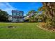 Beautiful two-story blue house with a wraparound porch, green lawn, and a gazebo in the backyard at 9122 16Th Avenue Nw Cir, Bradenton, FL 34209