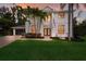 Stately two-story home with well-manicured lawn, lush landscaping and a paved driveway and walkway at 9122 16Th Avenue Nw Cir, Bradenton, FL 34209