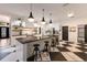 Stylish kitchen featuring a large island, modern pendant lighting, and black and white checkered flooring at 9122 16Th Avenue Nw Cir, Bradenton, FL 34209