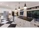Bright kitchen with a large island, stainless steel appliances, and black and white checkered flooring at 9122 16Th Avenue Nw Cir, Bradenton, FL 34209