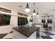 Spacious kitchen with a large island, modern pendant lighting, and views of the living area and backyard at 9122 16Th Avenue Nw Cir, Bradenton, FL 34209