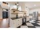Well-appointed kitchen featuring modern appliances, open shelving, and black and white checkered flooring at 9122 16Th Avenue Nw Cir, Bradenton, FL 34209