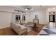 An open concept living room shows hardwood floors, neutral decor, and sliding doors to the outdoor area at 9122 16Th Avenue Nw Cir, Bradenton, FL 34209