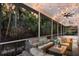 Covered patio with comfortable wicker furniture, string lights, and lush tropical views at 9122 16Th Avenue Nw Cir, Bradenton, FL 34209