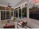 Screened patio with a ceiling fan and a seating area, perfect for enjoying the outdoors at 9122 16Th Avenue Nw Cir, Bradenton, FL 34209