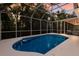 A partially shaded in-ground pool enclosed with a screen at 9122 16Th Avenue Nw Cir, Bradenton, FL 34209
