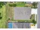 Overhead shot of backyard featuring sparkling pool, grassy lawn, and well-kept landscaping at 9123 Raes Creek Pl, Palmetto, FL 34221