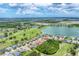 Overhead view of a neighborhood with lake views, surrounded by a lush green landscape at 9123 Raes Creek Pl, Palmetto, FL 34221